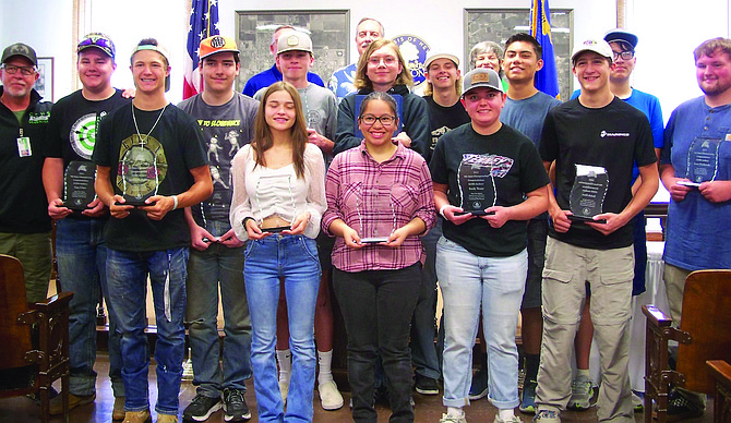 The Fallon City Council recently honored the Churchill County High School archery team for winning a ninth state championship. Front row from left: Jaiden McFadden, Rebeckah Saling, Annaleyah Davis, Emily Tenney, Isaiah Dart and Isaac Nestlerode. Middle row: Coach Dean Schultz, Case Utter, Steven Pine, Kaden Solinski, Daniel Harris, Tanner Huckaby, Cameron Christy and Franklin Sabanovich. Back row: Councilman Paul Harmon, Mayor Ken Tedford and Councilwoman Kelly Frost.