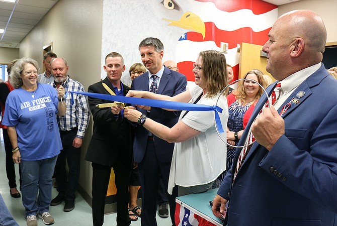 Western Nevada College Veterans Resource Center coordinator John Jacobson, center left, President Kyle Dalpe, and employee Cherrice Dotson cut the ribbon Wednesday with Assemblyman Ken Gray, far right, to celebrate the center’s grand opening.