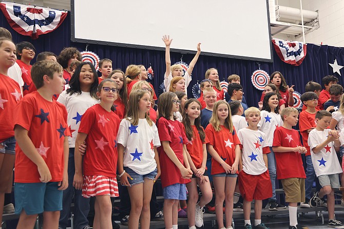 Minden Elementary School fifth-graders show the red, white and blue Wednesday in honor of Flag Day.