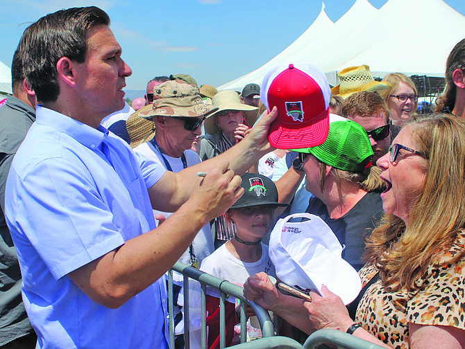 After his speech, Florida Gov. Ron DeSantis autographs a hat on Saturday at the eighth annual Basque Fry.