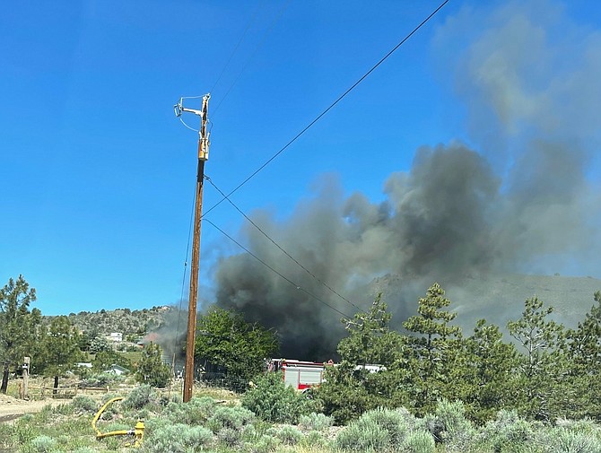 Smoke rises from a home on fire on Lava Court in Topaz Ranch Estates.