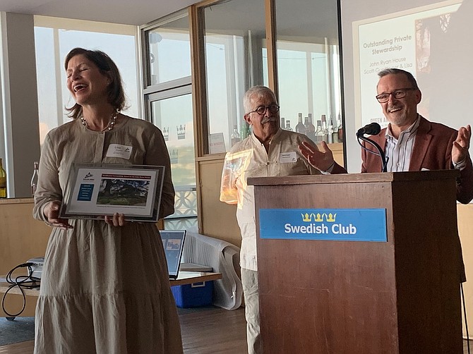 While receiving the Residential Stewardship Award, Lisa Emerson and Scott Guettinger relate the story of how they purchased the John Ryan House.