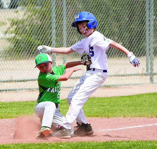 Fallon’s Jack Rowe hangs onto the ball for the out at third in Sunday’s 10U state championship win over Silver State.