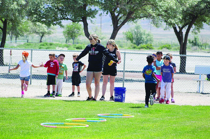 Leah and Alyssa Holland teach Lovelock youth a ball game at McDougal Park.