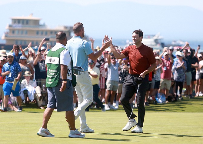 Tony Romo, right, reaches out to shake the hand of Mark Mulder after Romo sank the tournament-winning putt on the 18th green at Edgewood Tahoe last year.