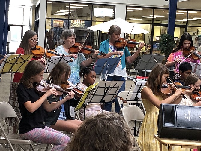 String players of all ages and experience levels perform in Carson City Symphony’s 'Strings in the Summer' concert last year at the Carson Mall.