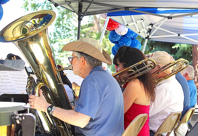 The brass section of the Carson Valley Pops orchestra performs in Heritage Park as part of Gardnerville's 2023 July Fourth celebration.