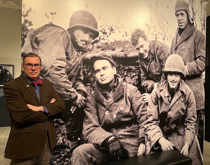 Rick Beyer, author of The Ghost Army of World War II, stands next to a photo of four of the soldiers who belonged to the unit. Upper left is the late Bob Tompkins of Gardnerville, who was a member of the special unit.