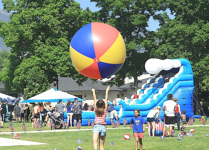 Children play with a giant beach ball at the Minden Fourth of July on Tuesday.