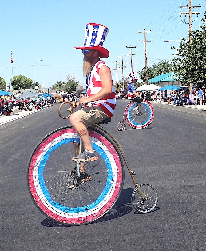 Robert, left, and Bryan Kaster ride their magnificent high-wheel bicycles to begin Fallon’s July 4 parade.