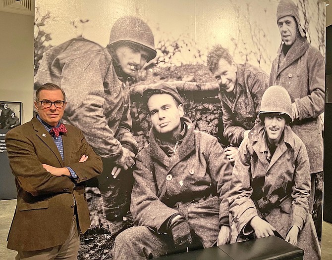 Rick Beyer, author of The Ghost Army of World War II, stands next to a photo of four of the soldiers who belonged to the unit. Upper left is the late Bob Tompkins of Gardnerville, who was a member of the special unit.