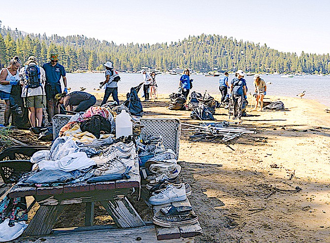 Volunteers gather up trash on Zephyr Shoals Beach on July 5. League to Save Lake Tahoe photo