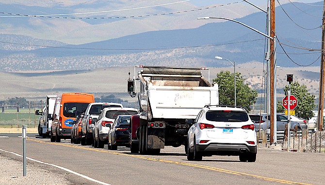 Vehicles wait to make a left turn on Muller Lane onto Highway 395 on Tuesday, some of which may be avoiding the collision at Spooner Junction.