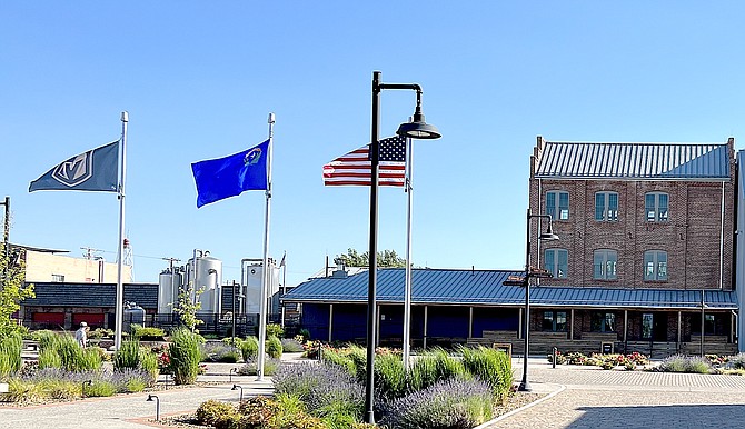 The Golden Knights flag flies, along with the Nevada state and U.S. flags on Thursday evening at Minden Mill Distilling.