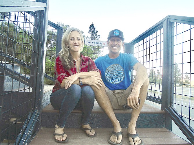 Aimee and Bill Scherbak in front of the Yoga Sierra studio above Mad Dog Cafe in Woodfords. Photo by Lisa Gavon