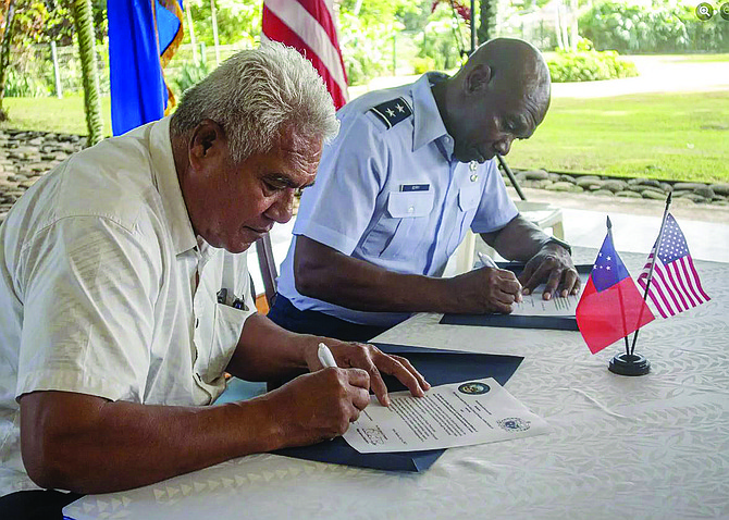 Faualo Harry Schuster, Samoa’s minister of police, prisons and corrections services, left, and Nevada Guard Adjutant General Maj. Gen. Ondra Berry sign the Declaration of Partnership between the Nevada National Guard and Samoa on July 6 in Apia, Samoa.