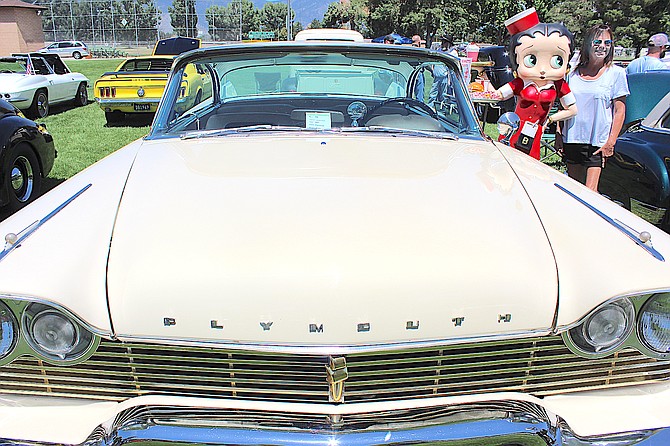 Gardnerville resident Sheree Sheets poses with a car hop that was part of the display for James Clark’s 1957 Plymouth Fury while Ron Spallone takes her picture. Spallone had his 1956 Chevy Wagon entered in the show.
