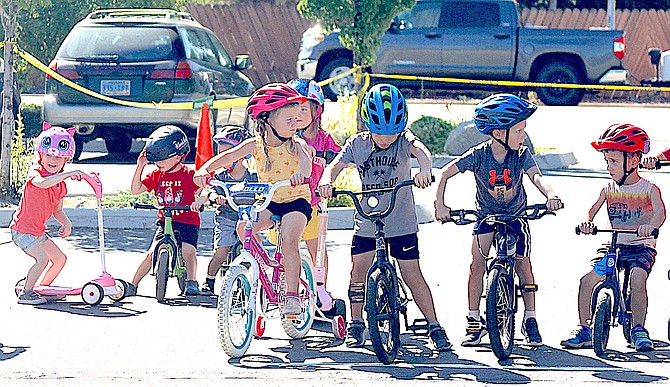 Trinity Lutheran Preschool students ages 3-5-years-old line up ready to pedal during the school’s Trike-A-Thon event Friday.