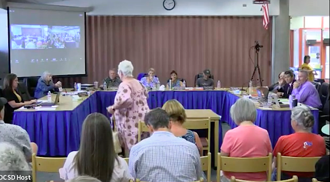At 4 hours and 19 seconds of the recorded public meeting, resident Sherry McGuffin is shown finishing up her comments when DCSD School Board President Susan Jansen is seen covering her mouth and can be heard saying, “He’s a piece of sh-t and so are you.”