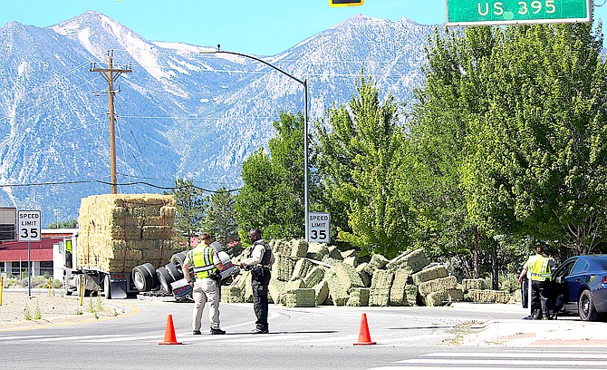 Douglas County deputies and a Nevada Highway Patrol trooper direct traffic around a spilled hayload at Highway 395 and 88 in Minden on Sunday morning. An hour later the NHP reported a fatal collision further north on Interstate 580 at Fairview Lane.l