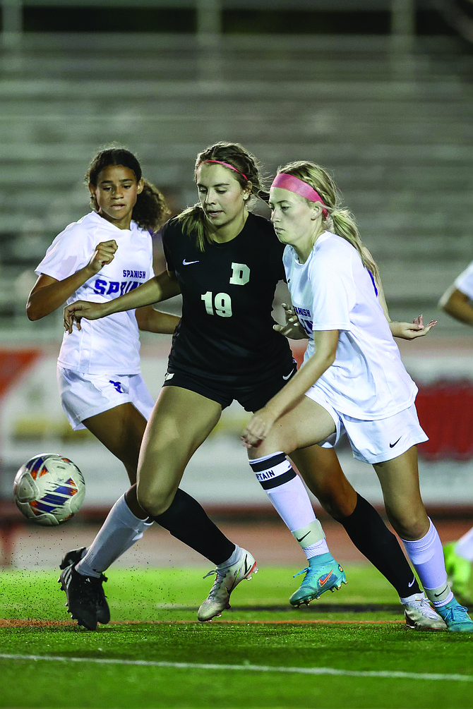 Douglas High’s Ava Coons battles for possession during a game last fall. Douglas and Carson girls soccer will be in Class 4A this fall after realignment by the NIAA.