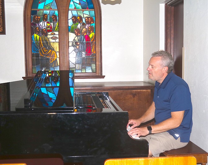 Trinity Lutheran’s new full-time Director of Music Ministry John Burns plays the piano in the chapel.