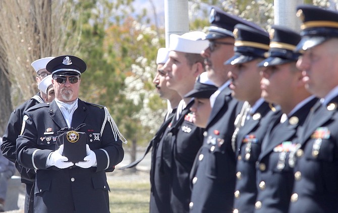 A member of the Nevada Veterans Coalition carries an urn at the Missing in Nevada service in 2019.