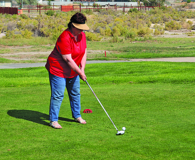 A player tees off at the 2022 Jim Regan Memorial Golf Tournament.