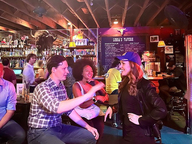 Andrew Lewis, candidate for D7 City Council, discusses the primary election results with Queen Anne Community Council Member Jazmine Smith and King County Council candidate Becka Johnson Poppe.