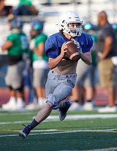 Carson High's Kincaid Gill rolls out of the pocket during Friday evening's scrimmage at Carson High School.