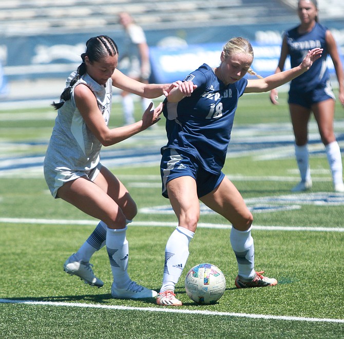 Bailey Rozier battles for possession during the Nevada women’s soccer blue and white scrimmage Sunday at Mackay Stadium. Rozier, a Douglas High alumna, joined the Wolf Pack after spending her freshman season with Truckee Meadows Community College.