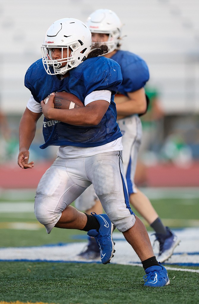Carson High running back Angelo Macias carries the ball during the Senators’ scrimmage Friday. Macias will be one of several ball carriers the Senators will rely on this fall.