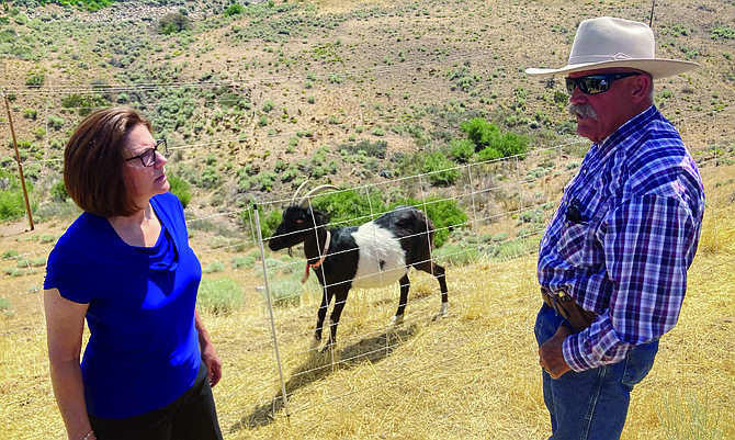 Sen. Catherine Cortez Masto (D-NV) speaks with Denton Cook, owner of High Desert Graziers, during a tour demonstrating fire prevention efforts in Washoe County.