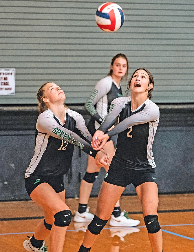 Fallon’s Halle Johnson, left, and Kiley Wallace pass the ball against Wells while Kaitlynn Hoffman looks on during the Yerington tournament Friday.