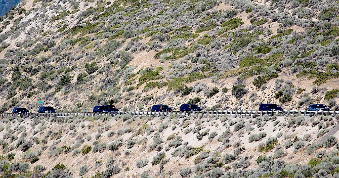 A motorcade makes its way down Highway 50 from Glenbrook on Saturday morning.