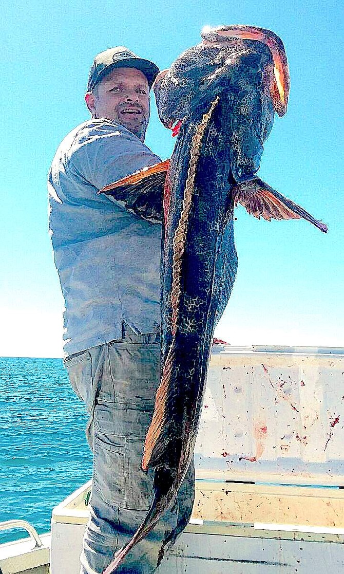 Doug Busey’s nephew Chris Hacker with a 50-pound lingcod that measured 47.5 inches long pulled from near the Rogue River in Oregon.