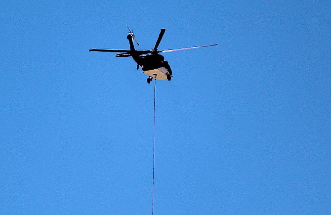 A helicopter flies power poles over Spooner Summit in August 2022 as part of the Glenbrook power project. Similar work will be conducted along Highway 28 starting after Labor Day.