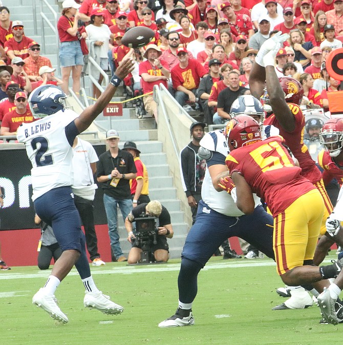 Nevada quarterback Brendon Lewis (2) looks to throw deep against USC Saturday afternoon at the Los Angeles Coliseum. USC defeated the Pack 66-14.