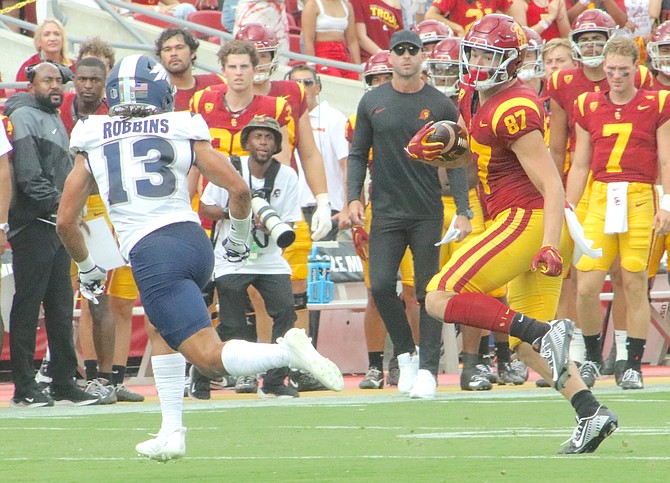 Defensive back Ezkiel Robbins (13) of Nevada takes aim on USC tight end Lake McRee (87) in Saturday’s collegiate game between the Wolf Pack and Trojans at the Los Angeles Coliseum. USC defeated the Pack 66-14.