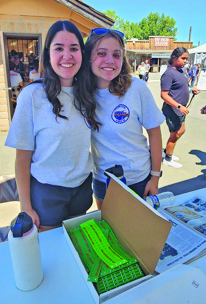 Anna Springfield, left, and Halle Feest volunteer at the Fallon Cantaloupe Festival.