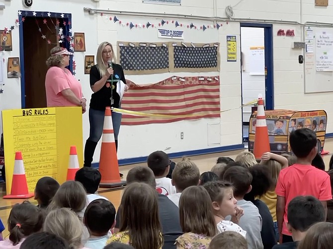 Churchill  County School District Transportation Manager Natasha Domes, left, and bus driver JeanE Workman giving a presentation to students at E.C. Best Elementary School.
