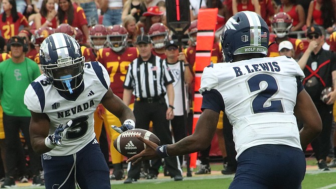 Nevada quarterback Brendon Lewis, shown handing off to Jamaal Bell, finished 18-for-29 in his Wolf Pack debut.