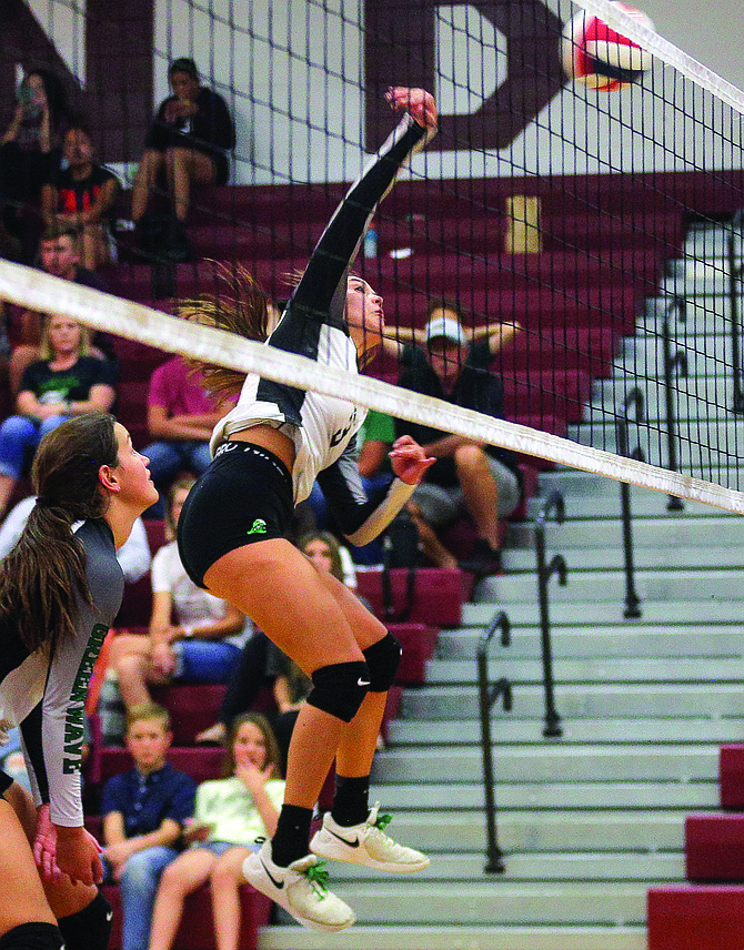Fallon’s Reece Hutchings attacks the net in the Greenwave's five-set win over Elko on Saturday.