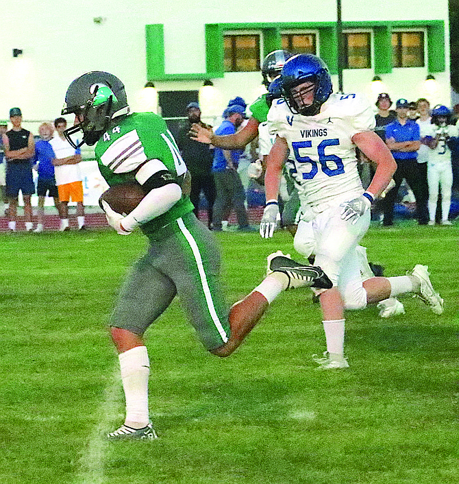 Fallon’s Manuel Karaway (44) takes off for a short touchdown run Friday after intercepting a pass. South Tahoe’s Rhyder Bruner trails.