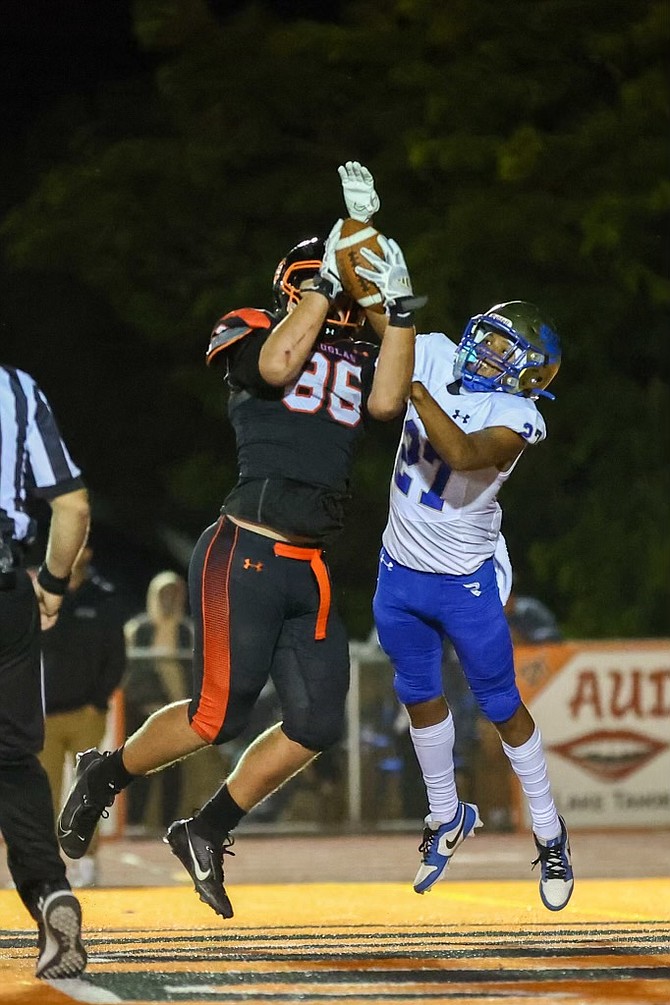 Douglas High's Nathan Stevens (86) jumps up to catch a 2-point conversion, during the Tigers' contest with Reed. The successful try brought Douglas within seven, 21-14, but it was as close as the Tigers would get on the evening.