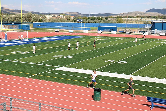 Carson High School junior varsity soccer players practice Wednesday on the school’s football field.