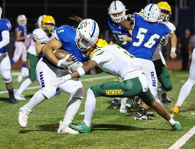 Carson High tailback Angelo Macias lowers his shoulder, during the Senators’ loss to Bishop Manogue. Macias is getting help on the play with a block from Sergio Villanueva (56).