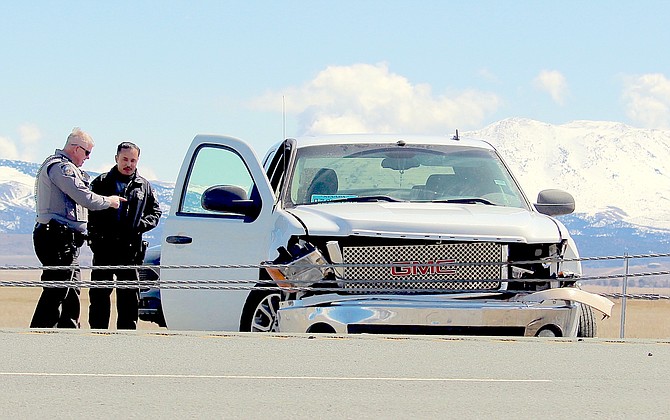 Nevada State Police troopers examine a pickup driven into the center barrier of Highway 395 on March 24 after a short chase witnessed by motorists just north of Minden