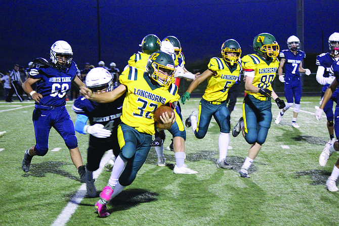 Battle Mountain's James Spealman outruns the North Tahoe defense on his way to scoring a touchdown against the Lakers on Friday night.