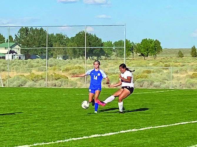 Lowry's Kepa Hilbish defends a Pershing County player during a match on Sept. 13.